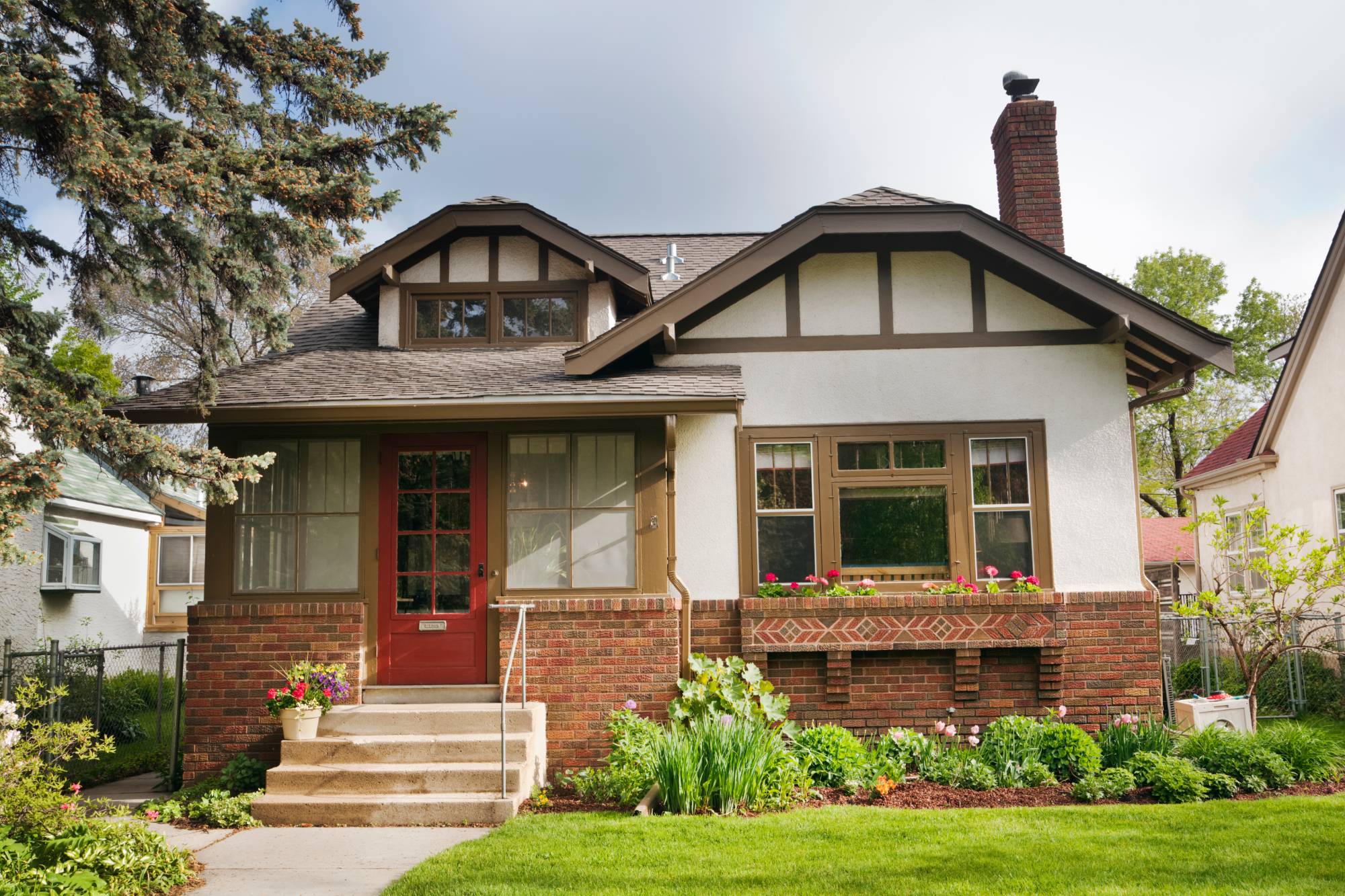 Stone and siding ranch home with a bluestone walk
