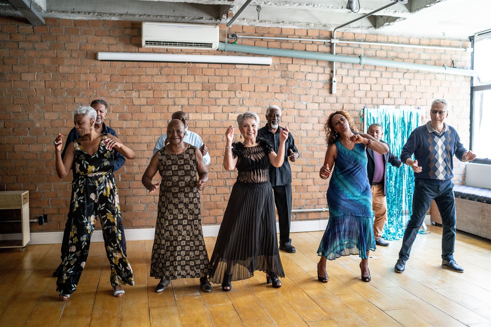 Active seniors dancing together at a social event