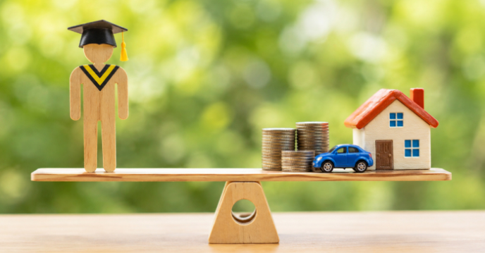 Graduate figure balanced on a seesaw against coins, a toy house and car, illustrating student loans versus buying a home