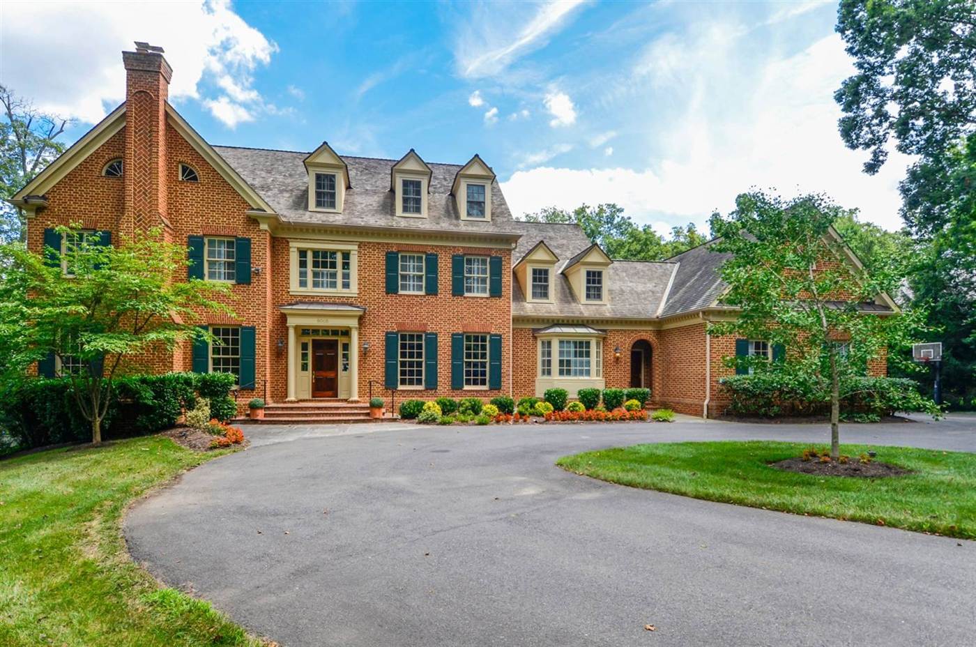 Georgian brick home with a circular driveway