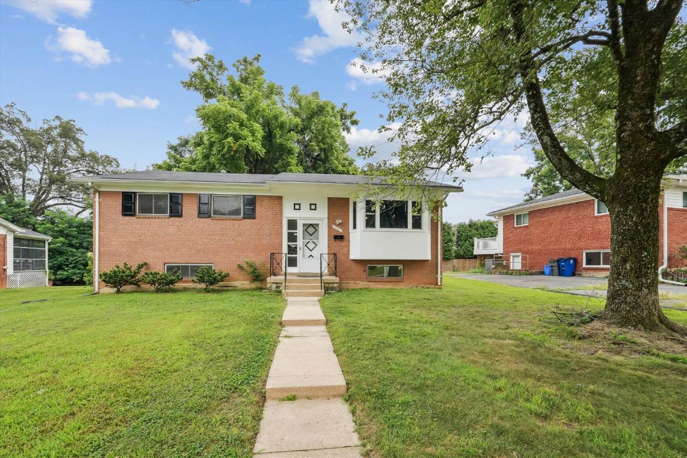 Brick split-foyer home with a shady front lawn