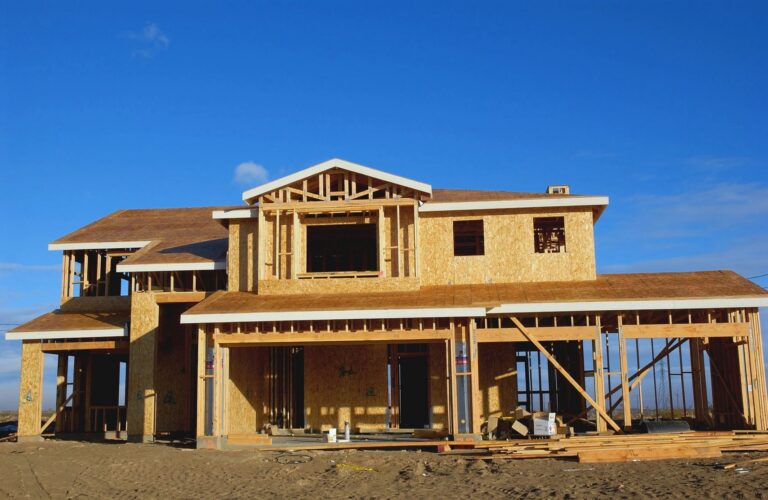 New home under construction in Montgomery County, Maryland, with wood framing and sheathing against a blue sky
