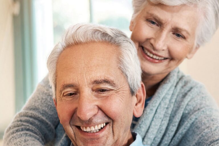 Smiling senior couple looking at a tablet together